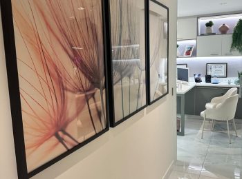 Três quadros no corredor da clínica